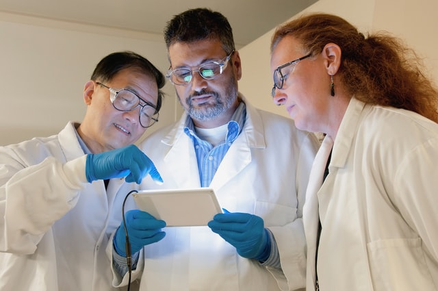 group of doctors looking at iPad