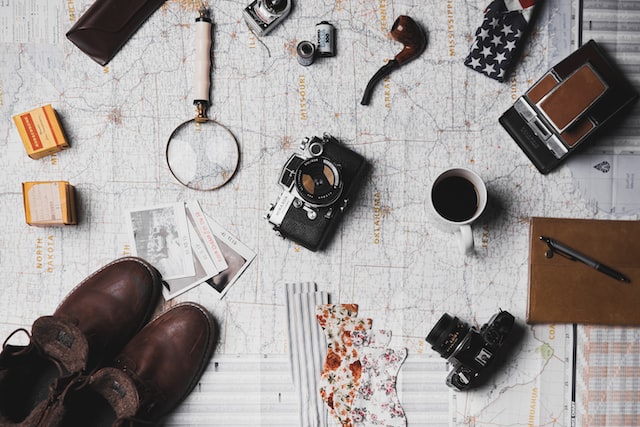 travelling map with camera and tourist accessories on top of the map